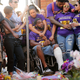 Marcus Martin (C), who was injured when a car plowed into a crowd of people protesting against the white supremacist Unite the Right rally, his fiancée Marissa Blair (behind with arms around Marcus) and friends visit the memorial built at the place where he was injured and where where 32-year-old Heather Heyer was killed in the same attack August 13, 2017 in Charlottesville, Virginia. (Photo by Chip Somodevilla/Getty Images)